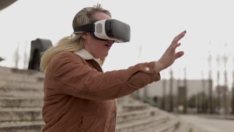 Excited-mature-woman-with-VR-headset-outdoor
